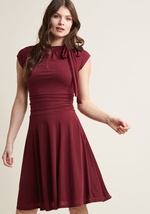 Jump into this burgundy dress and meet your darling on the dance floor! The bow-topped neckline of this look bounces with your every tango step, while the ruched details hug your waist as you flash your footwork. With a retro-infused shape, this pretty pi by MDD1155