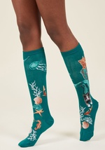 We've never laid eyes on a pattern as quirky as the mixed-breed kitties on these teal knee socks! Amid orange, amber, grey, and white oceanic motifs, lovable 'meow-maids' glide and swim, looking for an ear-scratch or a treat. by 