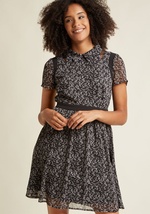 This black A-line dress introduces element of femininity, edge, and sophistication into your look all at once! It's the unique combo of grey wildflowers, black mesh shoulder accents, and a button-free bodice that make this chiffon shirt dress what it is.  by D9797