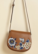 From brunch dates to boutique hops and beyond, there isn't a scenario out there that wouldn't welcome this tan satchel! The rounded silhouette of this faux-leather shoulder bag is host to a cool-toned collection of embroidered blooms and butterflies - det by 