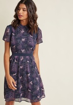 This navy A-line dress introduces element of femininity, edge, and sophistication into your look all at once! It's the unique combo of purple dots and ponies, mesh shoulder accents, and a button-free bodice that make this chiffon shirt dress what it is. A by D9797