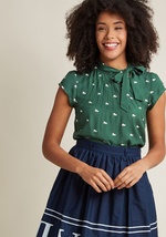 It&rsquo;s a bird! It&rsquo;s a plane! No, it&rsquo;s the lofty and lovely feeling inspired by this ivory blouse! A bold print of red, yellow, navy, and mint butterflies graces this cap-sleeved top, while a neck tie and pintucking elevate your look to new by CB115