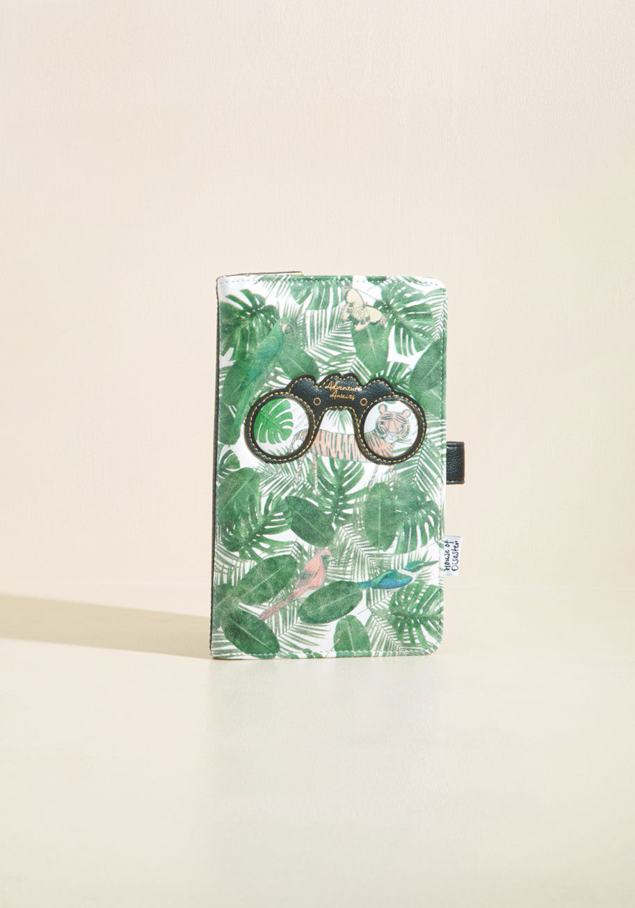  - Before you even board the plane, you'll feel whisked away to lush locales by having this faux-leather travel wallet from Disaster Designs handy! A green jungle print and binocular motif detail the exterior of this 'tropi-cool' essential, while its colorfu