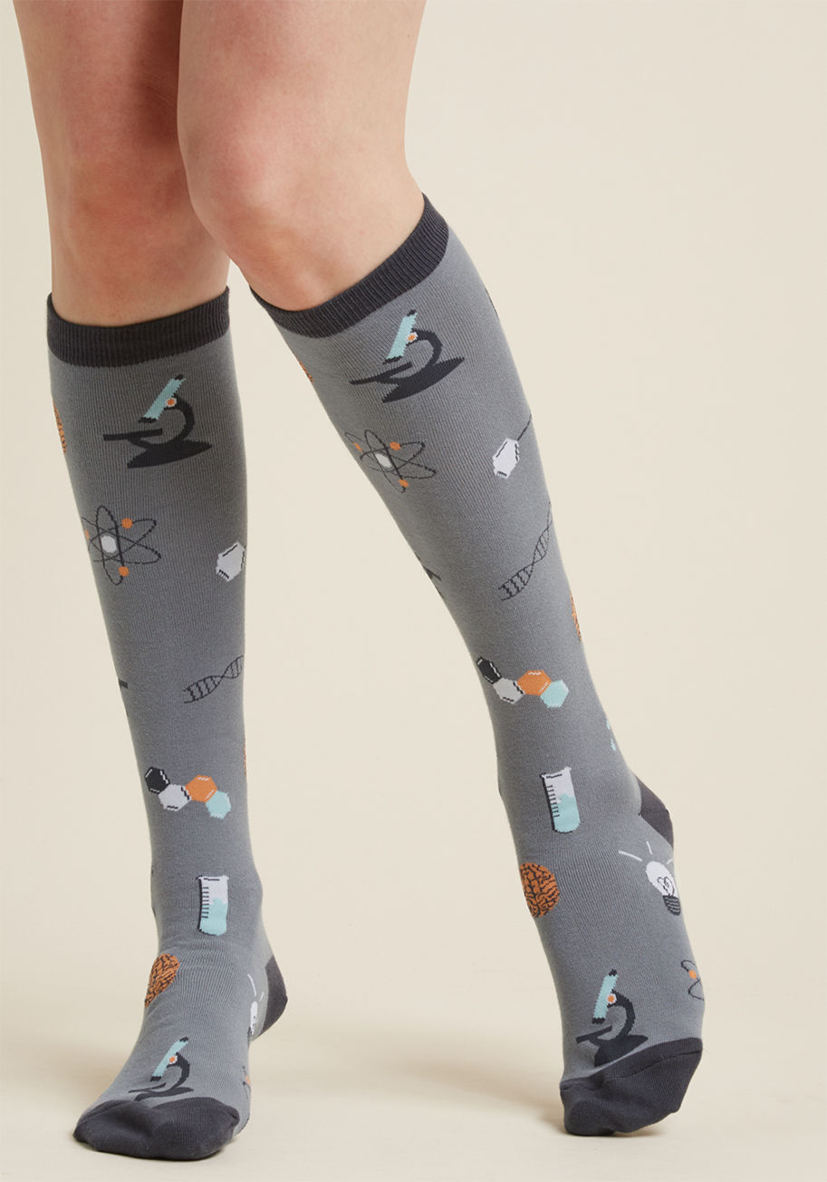  - Best case scenario would be sunshine all the time. But, if you've got to warm your toes, then these grey knee-high socks are one great way to do it! Experimental motifs like droppers, test tubes, brains, and helixes float around