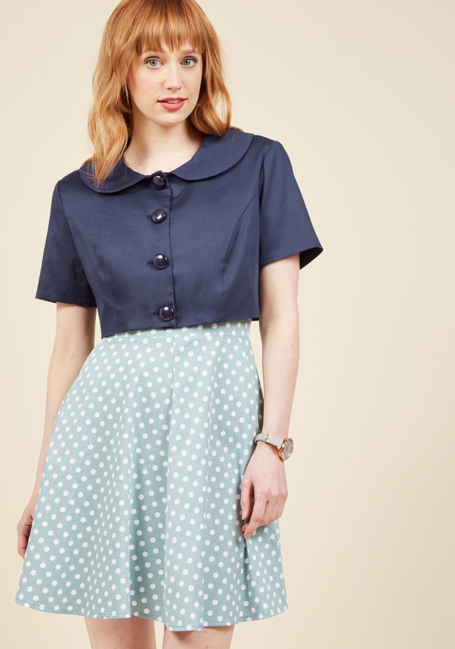  - Come one, come all, and gather 'round to hear all about the deets of this cropped navy jacket! Reviving a thoroughly retro look, this lovely layer by Collectif was designed to hold your attention with its round collar, glossy buttons, short sleeves, and s