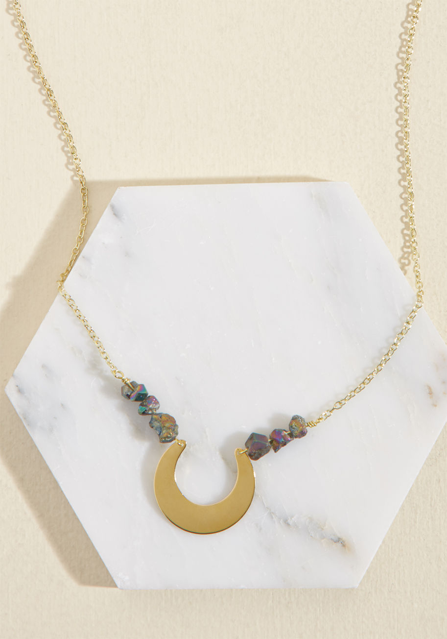  - Everyone loves having you around, and the addition of this celestial necklace to your outfit makes your presence all the more exciting! With iridescent titanium quartz stones strung along its golden chain and a bold brass crescent as its centerpiece, this