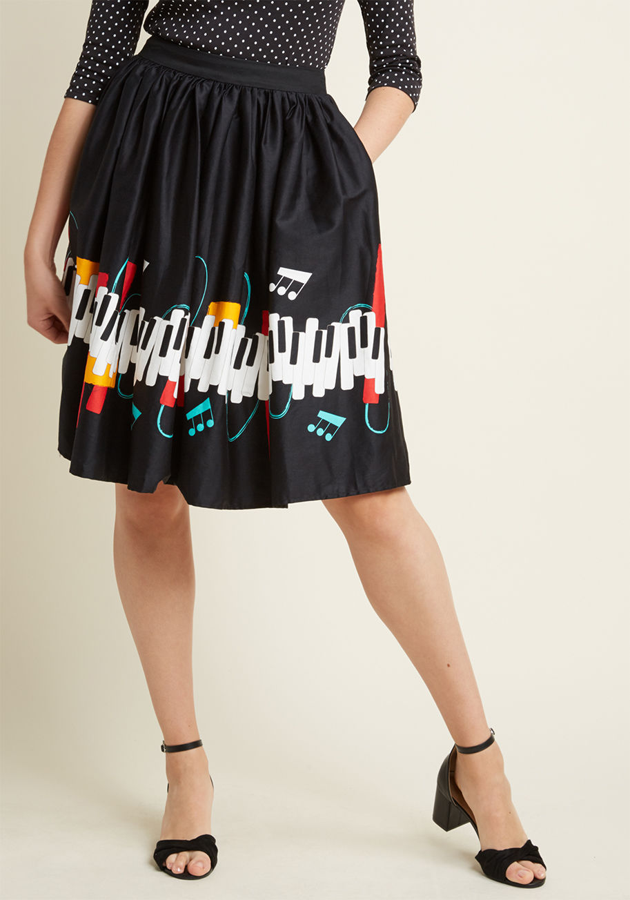  - Expect to acquire an adoring audience from flaunting this black midi skirt! The high waistline, pockets, and classic cut of this Collectif piece reference your love of nostalgia, while its colorful border print of piano keys, notes, and swirls speaks volu