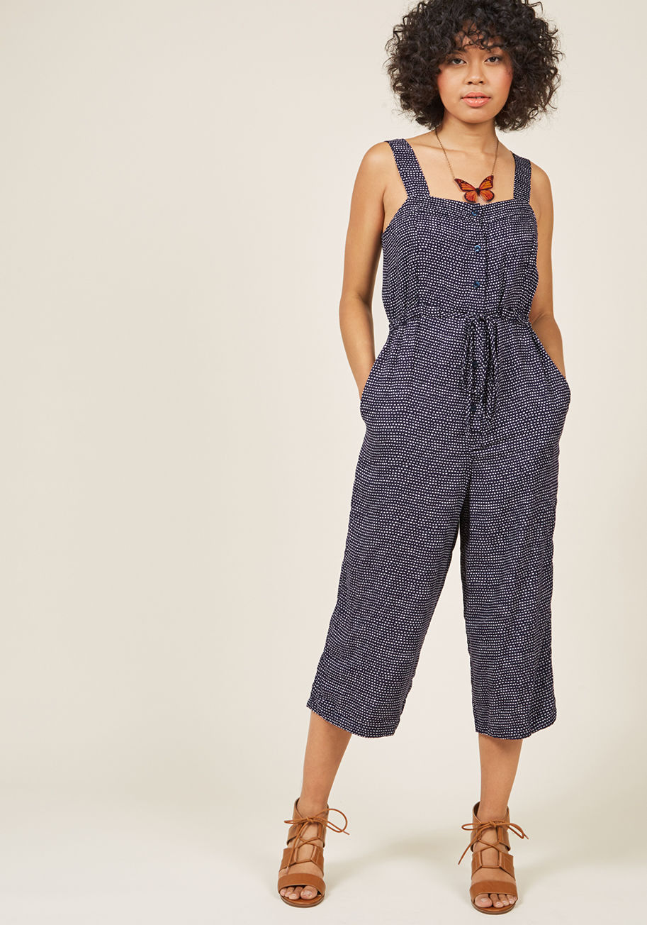  - For this navy blue jumpsuit's debut, you plan to leave the house unaccessorized - those local vendors are sure to have just the trinkets you're looking for! Hunting for the perfect pieces to accent the ivory dash pattern, drawstring-cinched waist, and loo