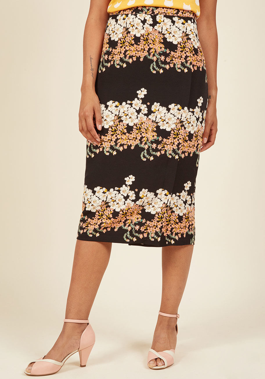  - From weekend brunches to weekday syncs, this black pencil skirt presents yourself at every gathering with the utmost poise! A full side zipper and rows of white pink, and green flowers give this midi-length bottom class and character - both of which are e