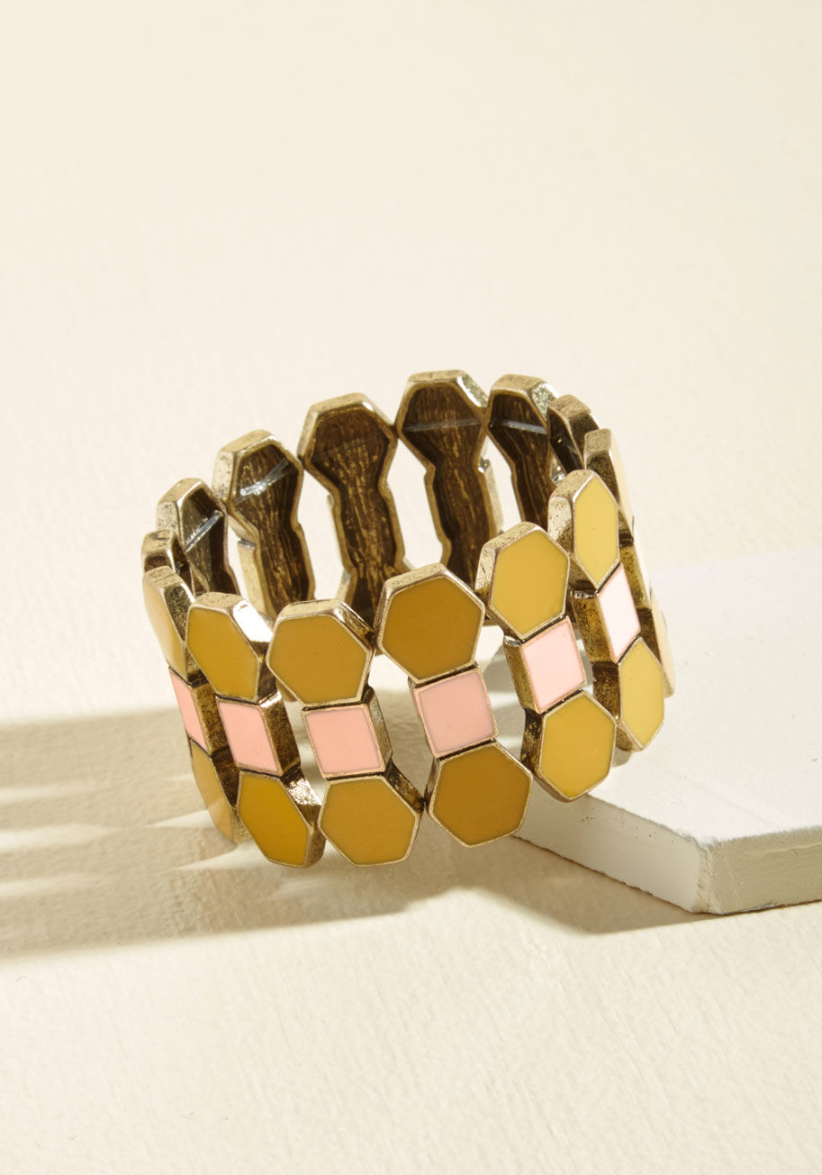  - Goodness gracious do we love this geometric bracelet! Its antiqued gold elements are pigmented with burgundy and mustard enamel, and strung along stretchy bands so this style can fit comfortably on your wrist for all sorts of occasions.