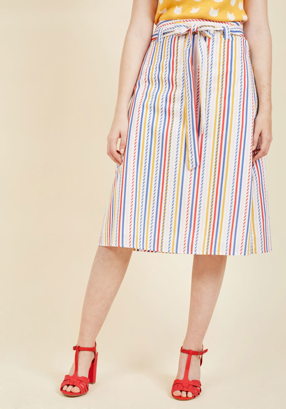  - If this cotton midi skirt could speak, we imagine it would sing with excitement over such a darling design! Inspired by the founding siblings' travels, this sash-tied sweetheart will make you feel equally giddy with its high waistline and red, blue, pink,