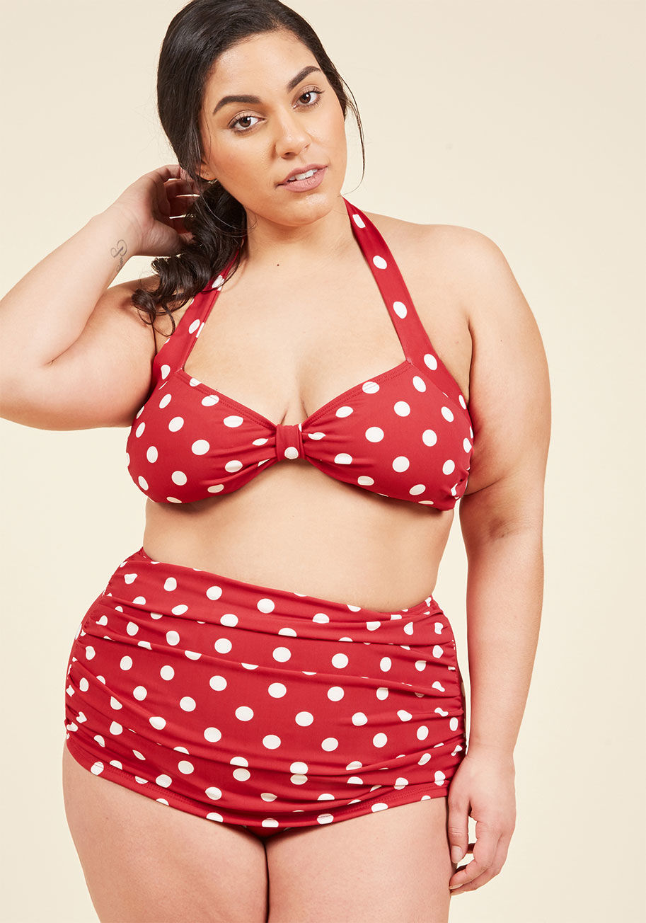  - Inspired by our favorite beach party film, this two-piece swimsuit is flattering on every body type. By the iconic Esther Williams and featuring a bold, allover polka dot print, low-cut legs, and flirty front ruching, this lavender suit will show off your