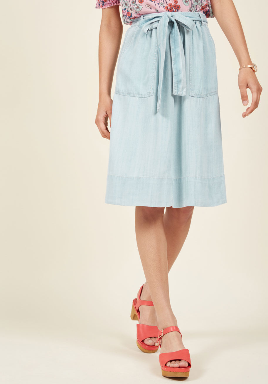  - It's exciting to imagine just how many delightful looks you can create with this chambray midi skirt at the center of each one! Blouses, tanks, tees, and more pair blissfully with the sash-tied high waist and spacious pockets of this easygoing piece - a b