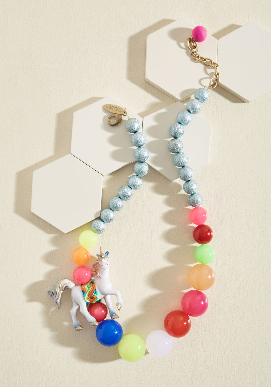  - Now, here's one statement necklace that'll get your creative juices flowing! Featuring colorful beads like blissful bubbles along which a friendship-bracelet-bound unicorn canters, and strings of sparkling silver bits that guide back to its adjustable gol