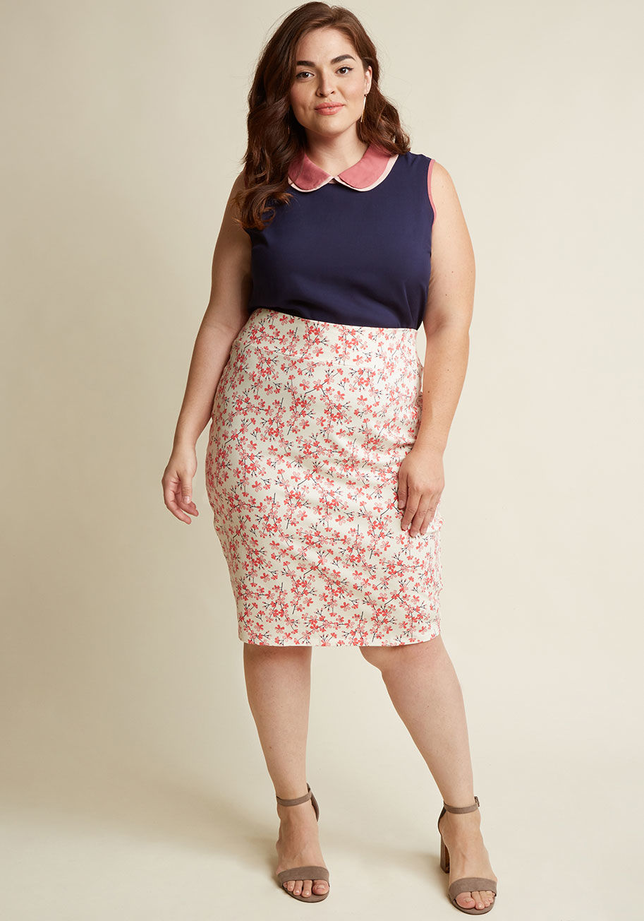  - On the days you want your outfit to do more than impress, you turn to this ivory pencil skirt to begin your impactful look. The high waist, comfy knit fabric, and cherry blossom print of this midi-length bottom pair beautifully with any pieces you please,