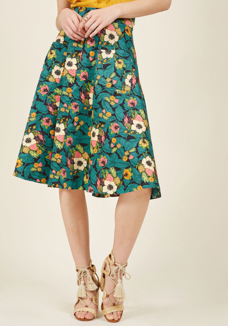  - Pool, patio, pasture, or park, this tropical midi skirt from Banned puts you on your own exotic island of panache! Patterned with teal palm leaves, bright hibiscus flowers, and a few servings of fruit, this black bottom is bold and beautiful. Plus, its hi