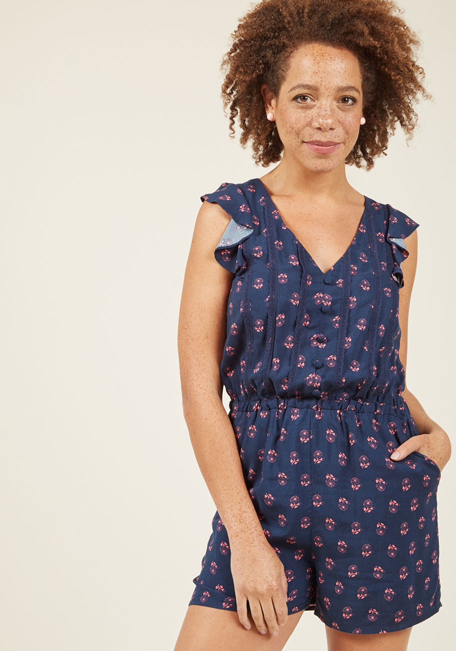  - The question is, where CAN'T you wear this navy blue-and-pink floral romper? Updated from a basic with feminine flutter sleeves, faux buttons and lace panels decorating its bodice, an elasticized waist, and pockets, this ModCloth namesake label playsuit m