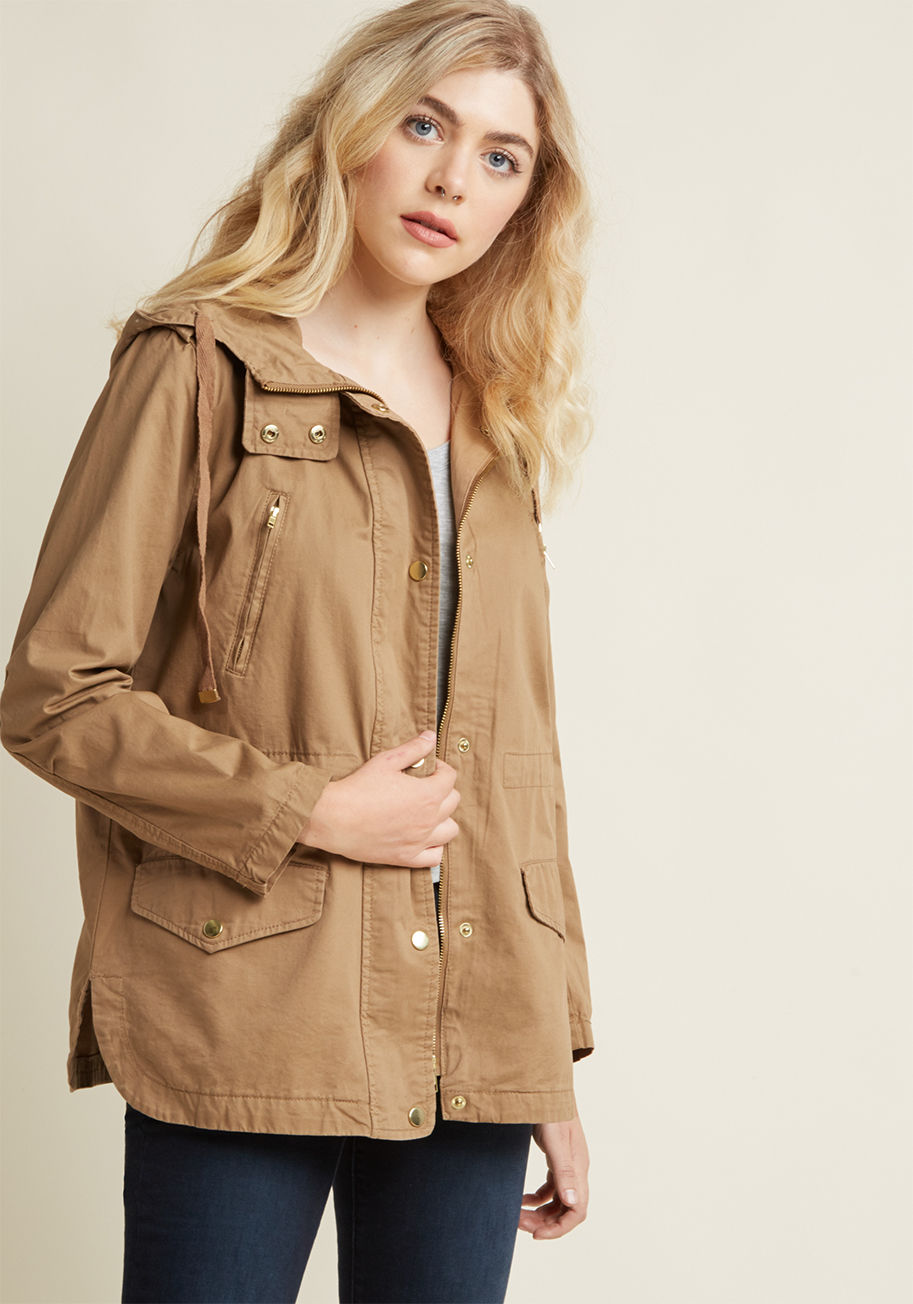  - There&rsquo;s nowhere you feel more at home than among the trees, tucked into this lightweight, earthy green coat! Golden snaps and zippers accent the this hooded cotton layer, while plentiful pockets offer a place to keep treasures from the trail. Now, g