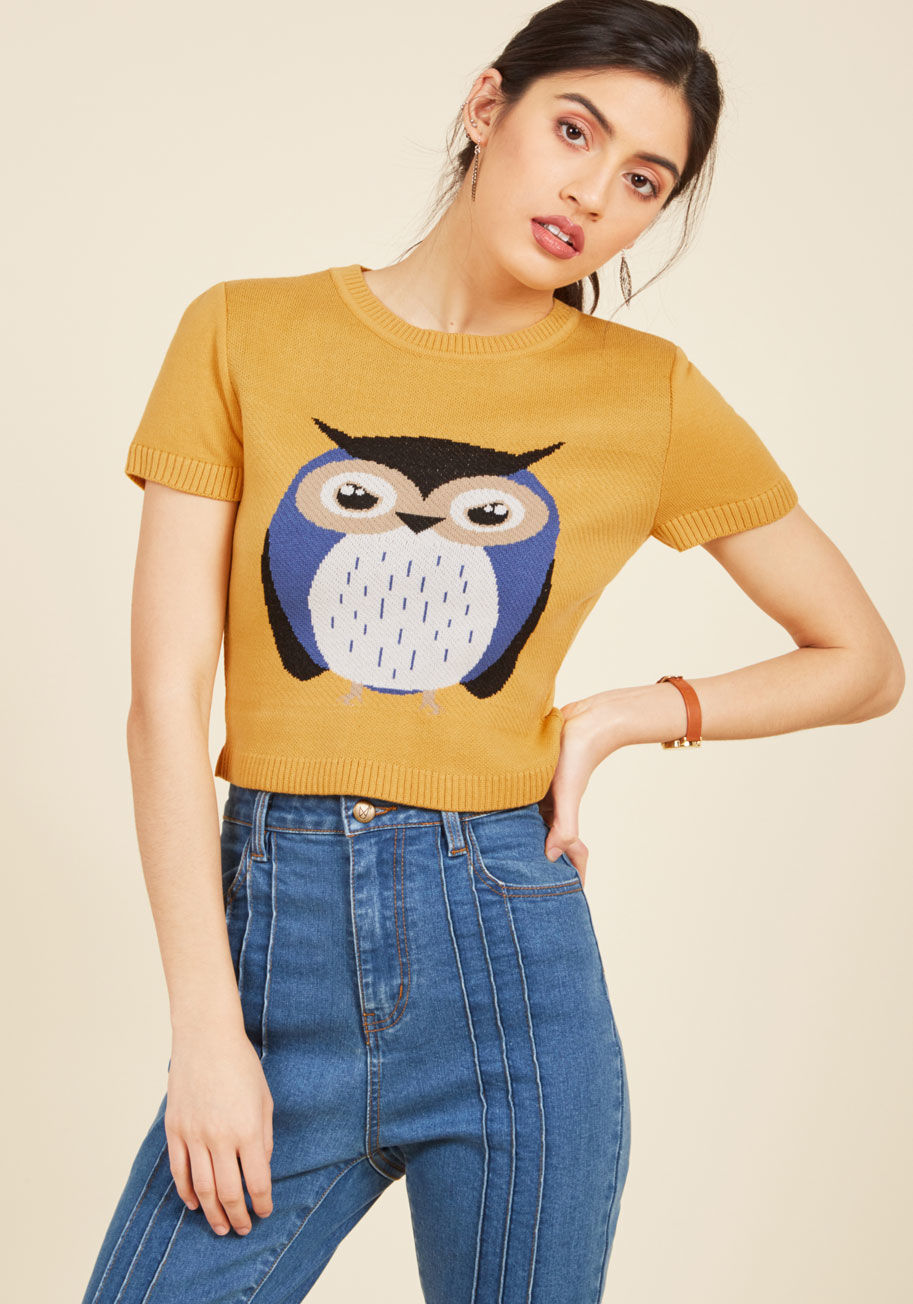  - There's no one way to display your singular style, but we believe that sporting this mustard sweater is a pretty good start! With a tan, purple, and black intarsia owl design decorating its cropped silhouette, this quirky short-sleeved knit exemplifies yo