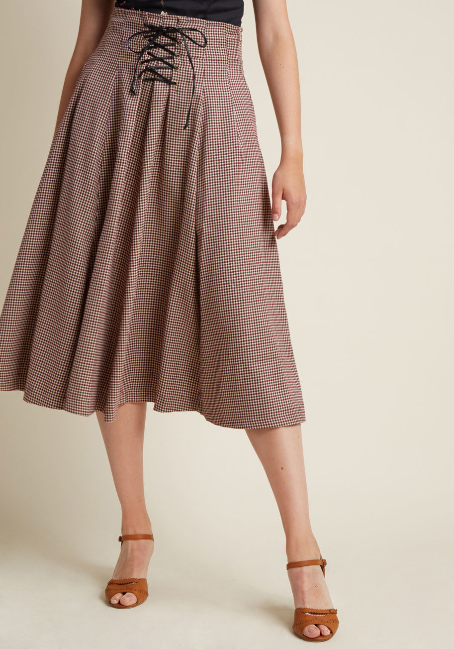  - This high-waisted skirt introduces vintage-inspired virtue to your leaf-identifying adventure. A burgundy, black, and tan, houndstooth-inspired plaid pattern and faux-leather laces pair up to bring backcountry brilliance to this pocketed bottom from Alice