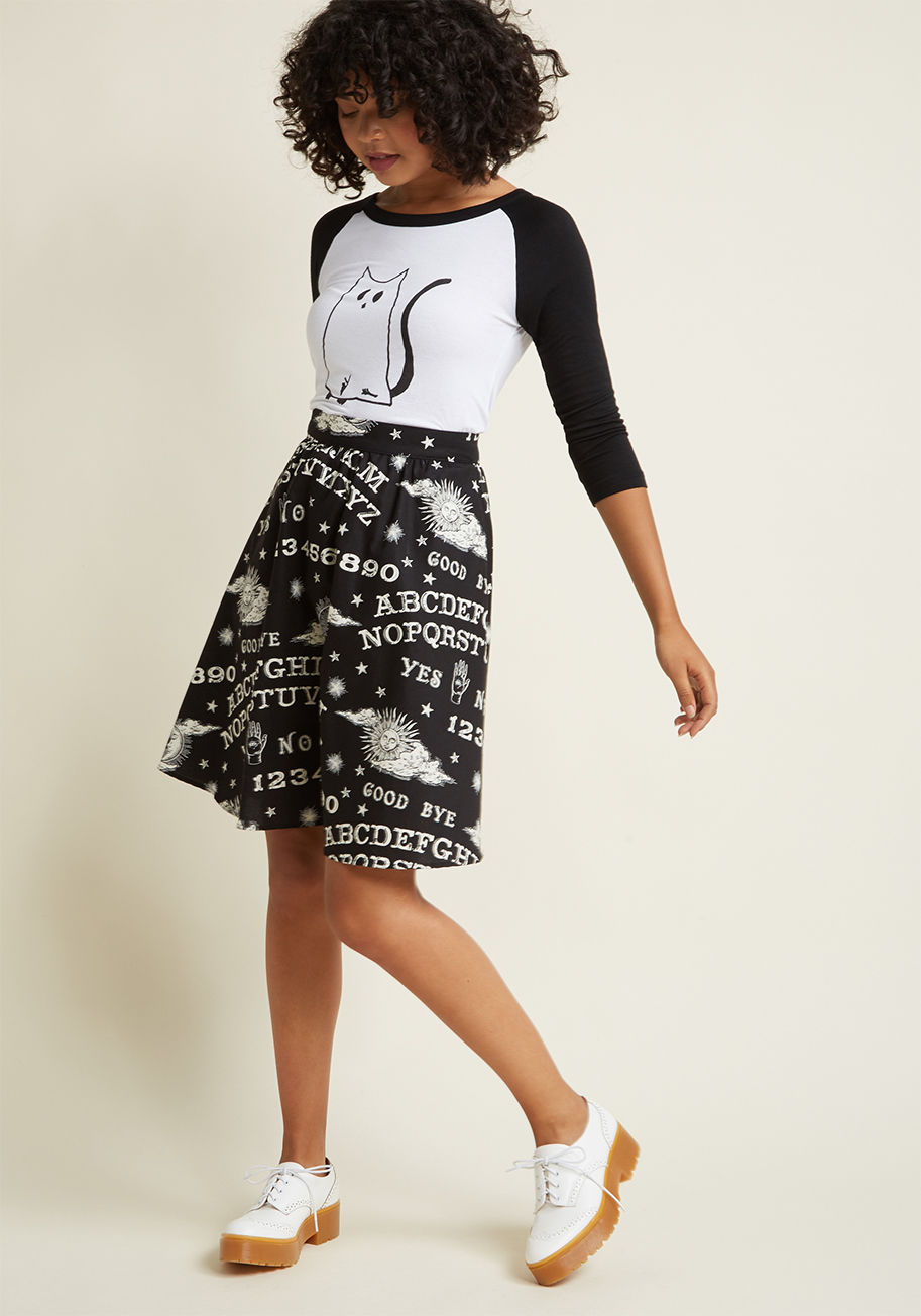  - This pocketed black skirt shows that texting is a thing of the past and mystical messages are in! Decorated with white, glow-in-the-dark ouija boards and occult-chic motifs, this cotton bottom channels otherworldly awesomeness.