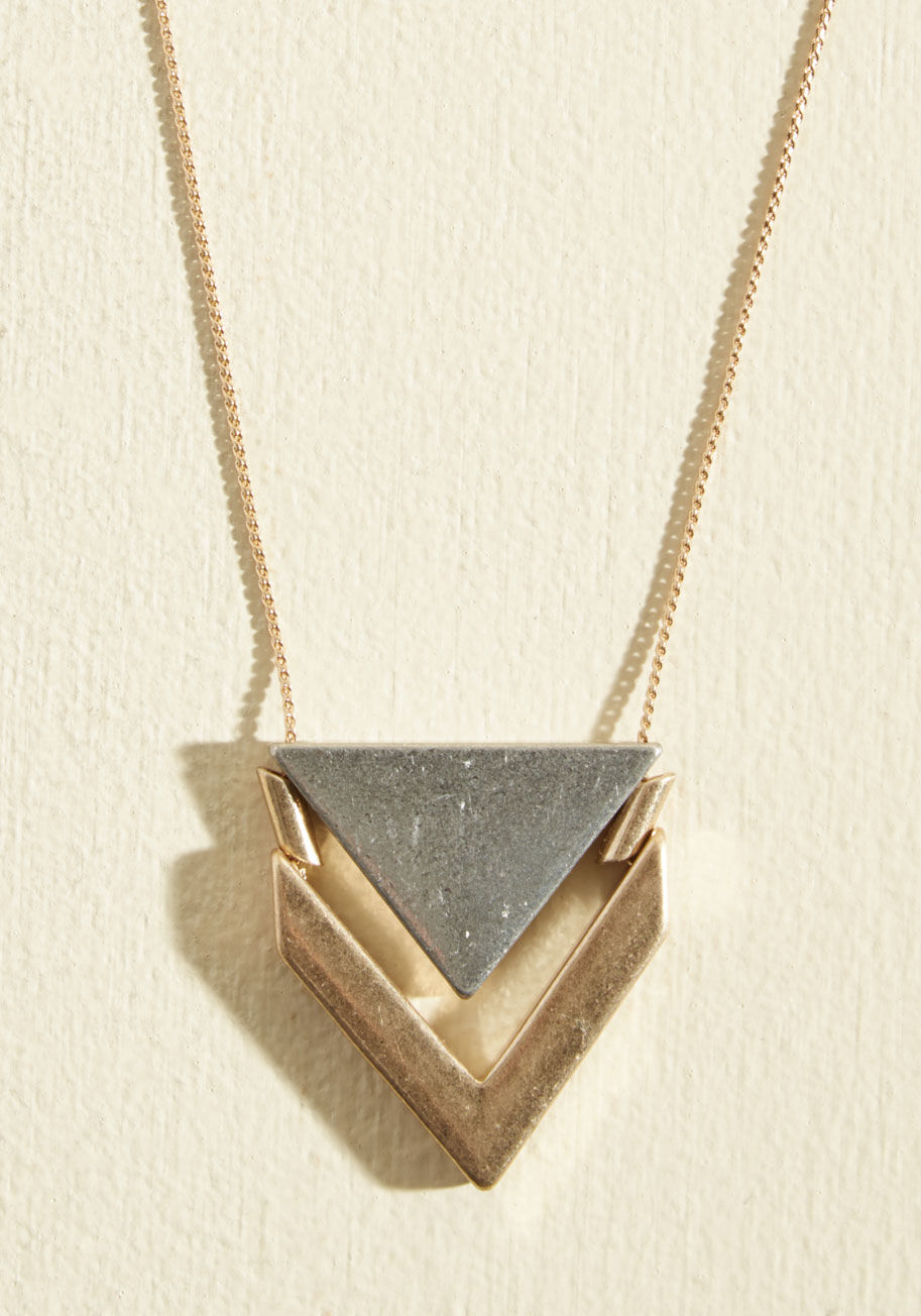  - This silver and gold necklace proclaims its cool flair with fabulous simplicity. A duo of weighty pendants - sleekly angled and polished - add modern appeal to any outfit. Enough said!