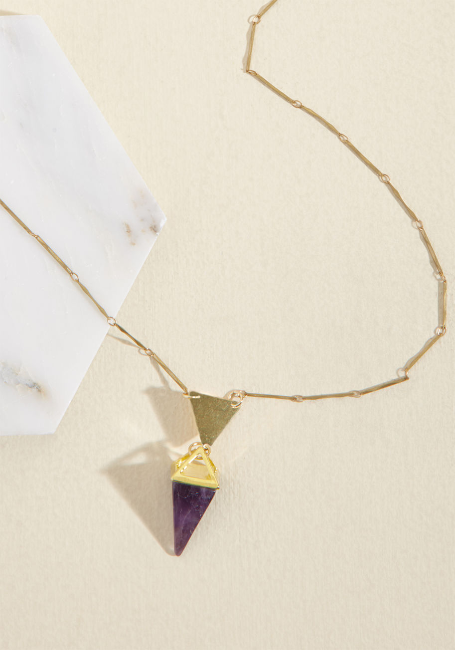  - Traditionally, amethyst represents calmness and clarity, but as soon as you clasp this necklace over your ensemble, it also takes on an element of aspiration and elegance! Hanging from a brass bar chain and part of a geometric pendant, this Eclectic Eccen