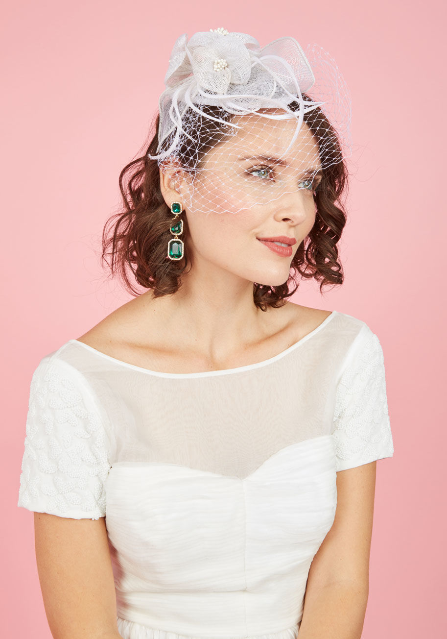  - We all have that side that craves making an impression, and with this sinamay fascinator, you stylishly free that bold feeling! Perched atop a black headband and ornamented with feathers, flowers, and fab netting to veil the eyes, this taupe topper is ter