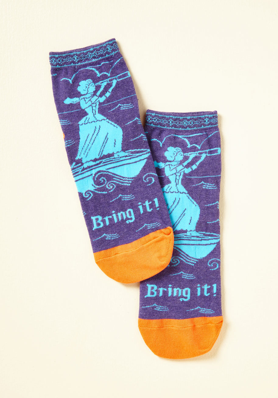  - We challenge you to an adventure! With these purple and orange ankle socks tucked into your boots, you're ready to ruckus. Displaying a sky blue 'seastress' sailing atop a provoking phrase, this sassy pair arouses your audacious spirit!