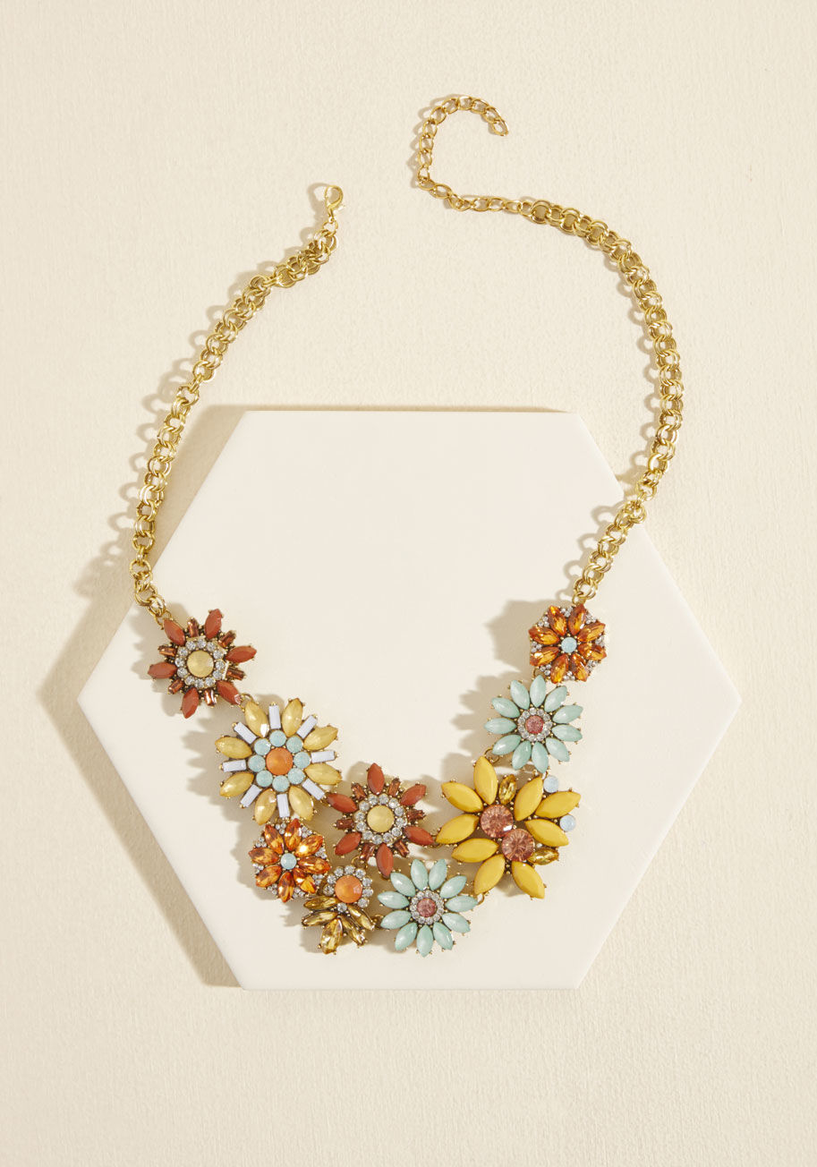  - We sense you sporting this faux gemstone-encrusted necklace one, twice, three times - it's a new staple! Showcasing a display of mint, mustard, orange, amber, and auburn petals all strung along a gold chain, this sweet accessory is sure to win smiles.