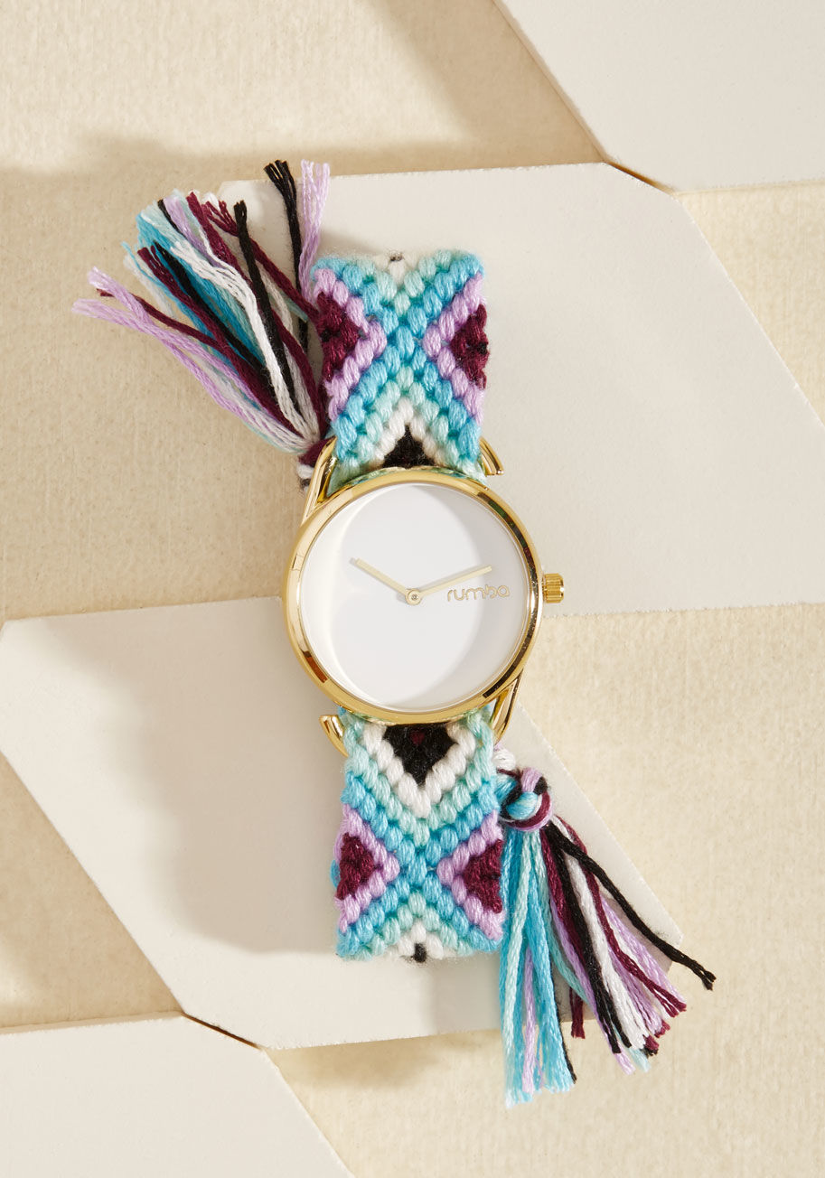 While wearing this colorful watch by RumbaTime, you'll find yourself looking back on the fondness of simpler days. Supported by a friendship-bracelet-inspired band woven with teal, white, and purple hues, this gold-trimmed timepiece offers equal parts lov by 