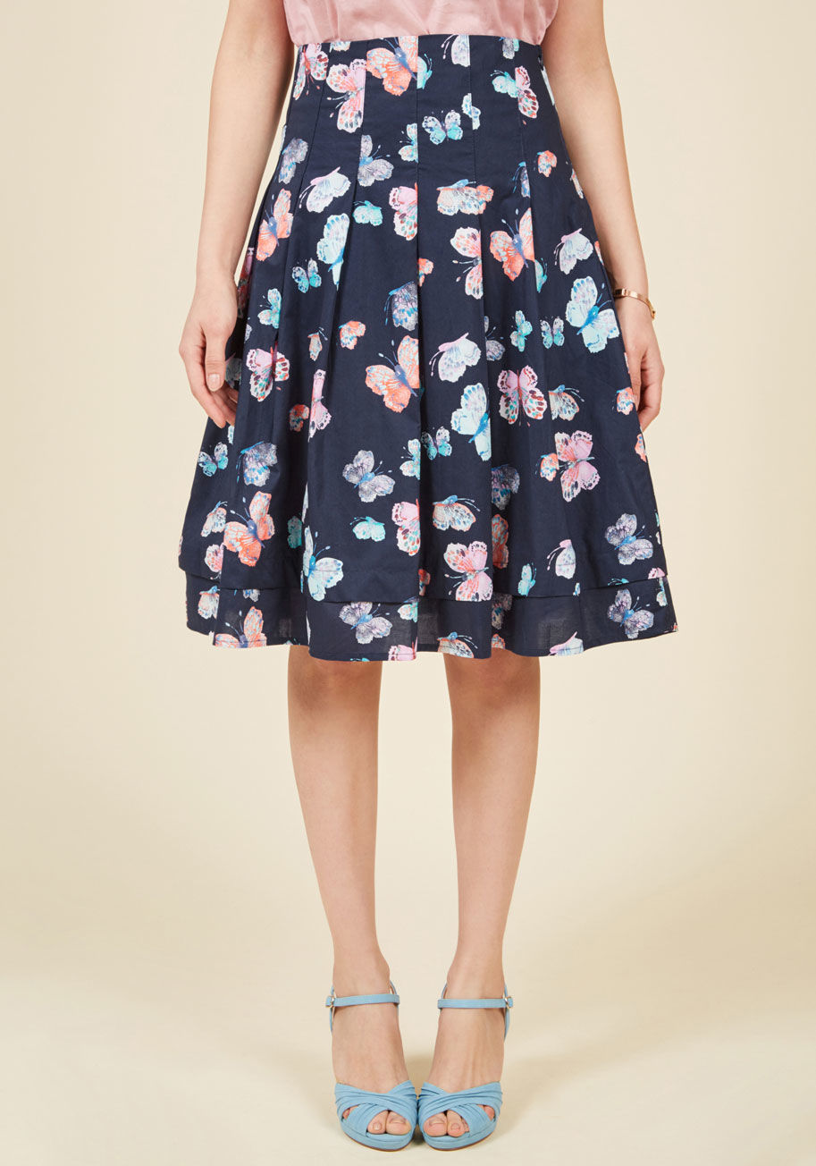  - You could get away with wearing this navy blue midi skirt for any number of occasions! Its pastel, painterly butterfly pattern is unarguably fitting for showers and brunches, while its pleated silhouette and subtly tiered hemline offer undeniable taste at