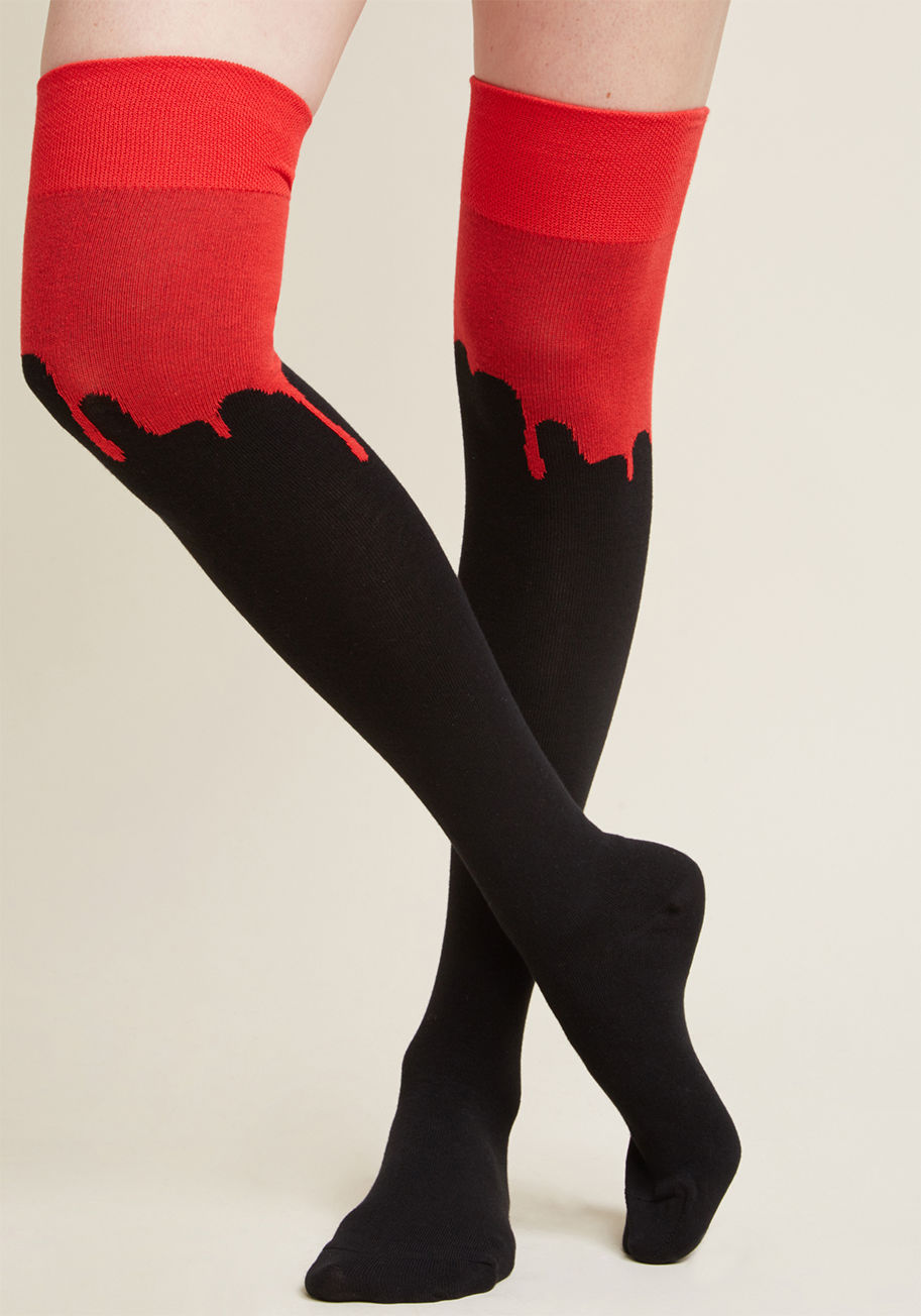  - You wouldn't be 'you' if you didn't depart with a statement. These over-the-knee socks feature bold red knees that daringly drip down into their black knit, oozing unmistakably macabre moxie. Talk about a spellbinding send-off!