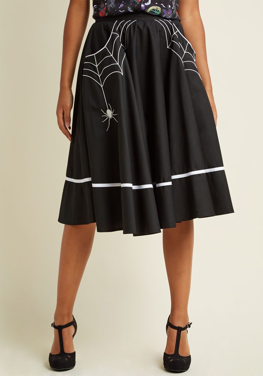  - Your style moods can change with the tides, but your love for quirky choices like this black skirt is everlasting! Featuring white trim and pockets upon which an eight-legged companion builds its home, this statement-making midi adds fun flair to a myriad