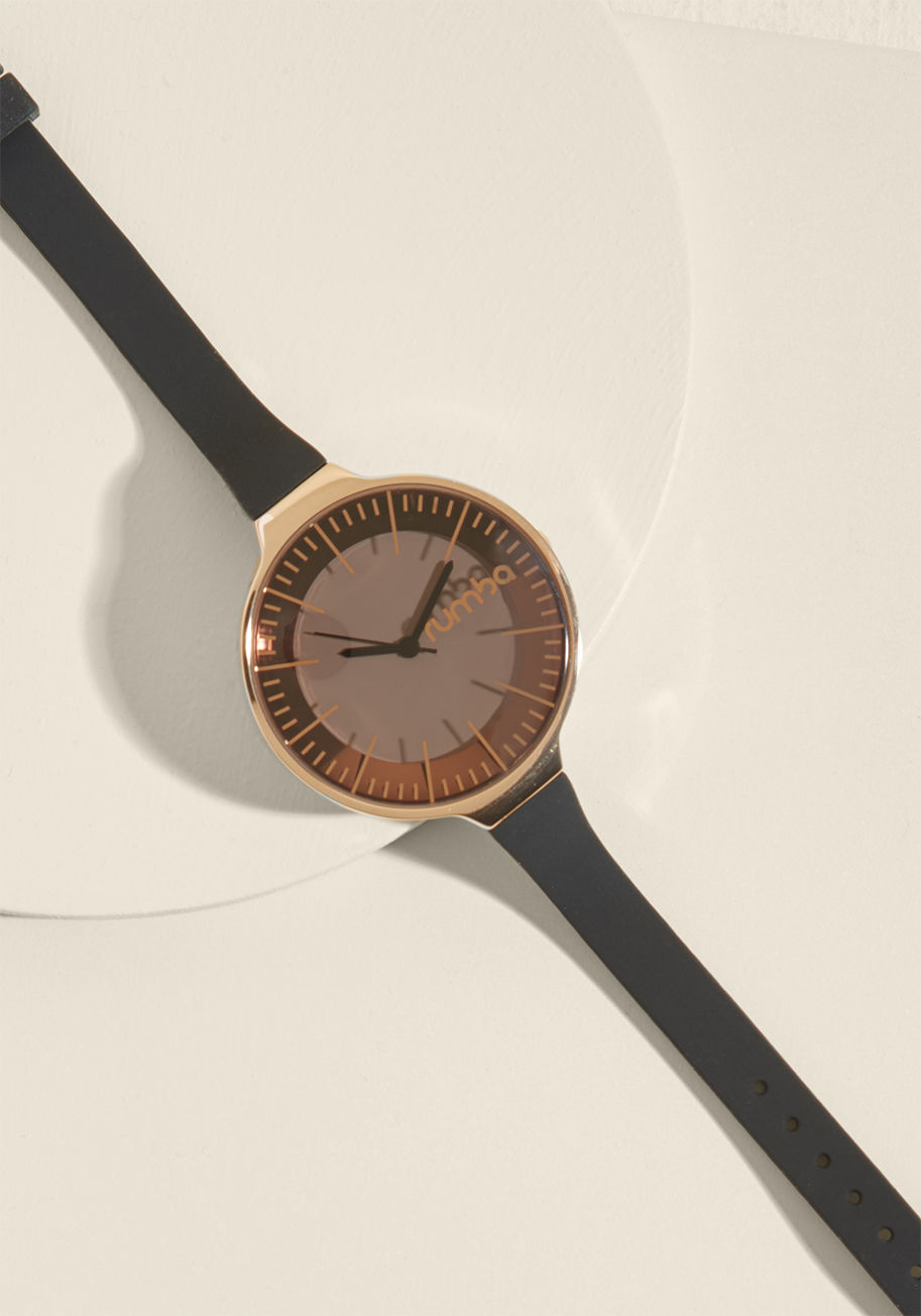 12382 - There's no question about it - this black watch adds an elegant touch to an already highly-fashionable outfit! With a slim strap and large, smoky face, this rose-gold-accented piece by RumbaTime gives you an effortless - and expressive - aesthetic elevati