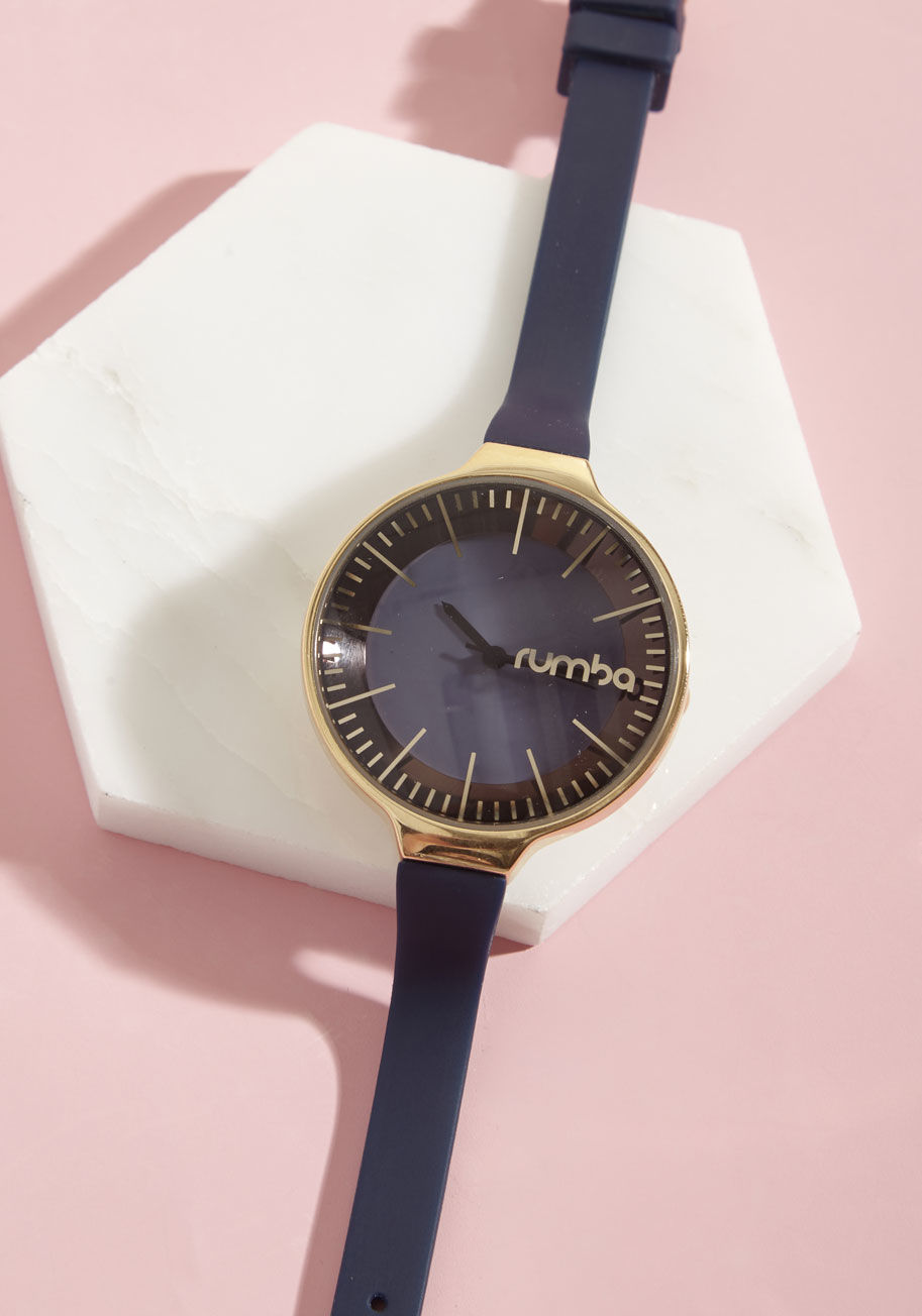 12399 - There's no question about it - this navy blue watch adds an elegant touch to an already highly fashionable outfit! With a slim strap and large, blue-cast face, this gold piece by RumbaTime gives you an effortless - and expressive - ensemble elevation.