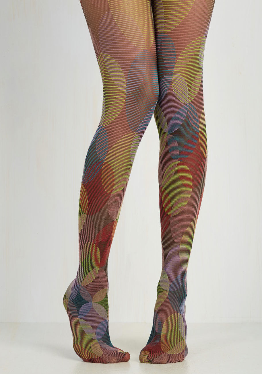 1393 - Recreate the heart-racing glow of a metropolitan evening by slipping into these brightly patterned tights. Swirling with magenta, navy, lime green, and lavender intersecting circles, this pair is reminiscent of the colorful themes that represent a night s