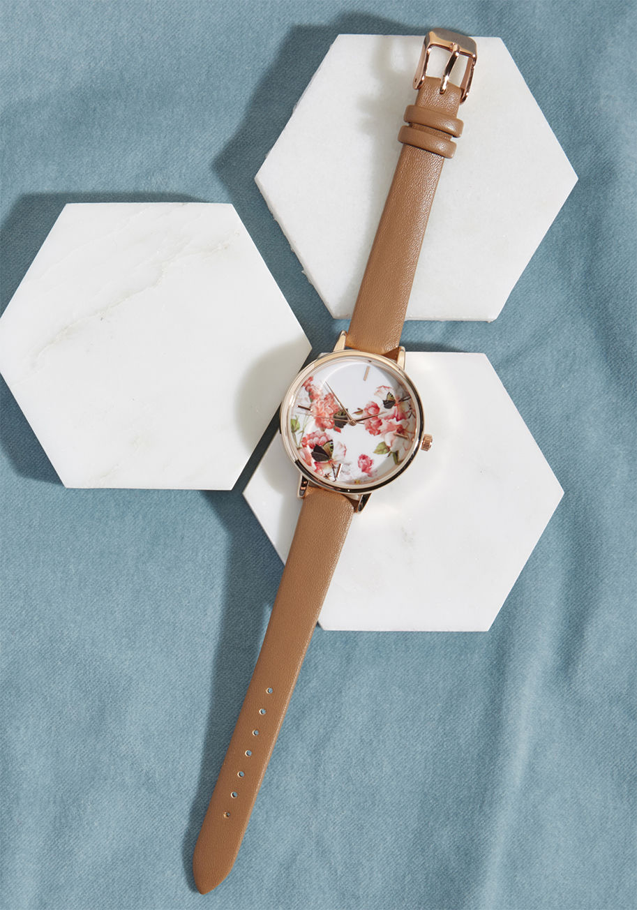 15256 - Make an entrance to remember by adorning your best ensemble with this rose gold watch. Featuring a faux-leather strap and a notched dial decorated with pink roses and a bright butterfly against a white backdrop, this accessory will get you noticed with ea