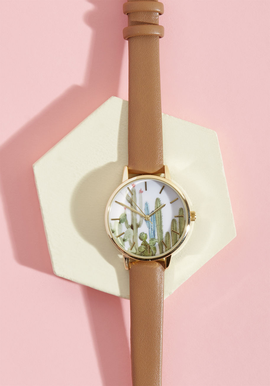 15265 - Establishing a routine is more pleasant than ever with this gold watch to keep you on time! Supported by light brown, faux-leather bands, flaunting a white face with pastel cacti painted on, and designed with elegant notches instead of numbers, this class