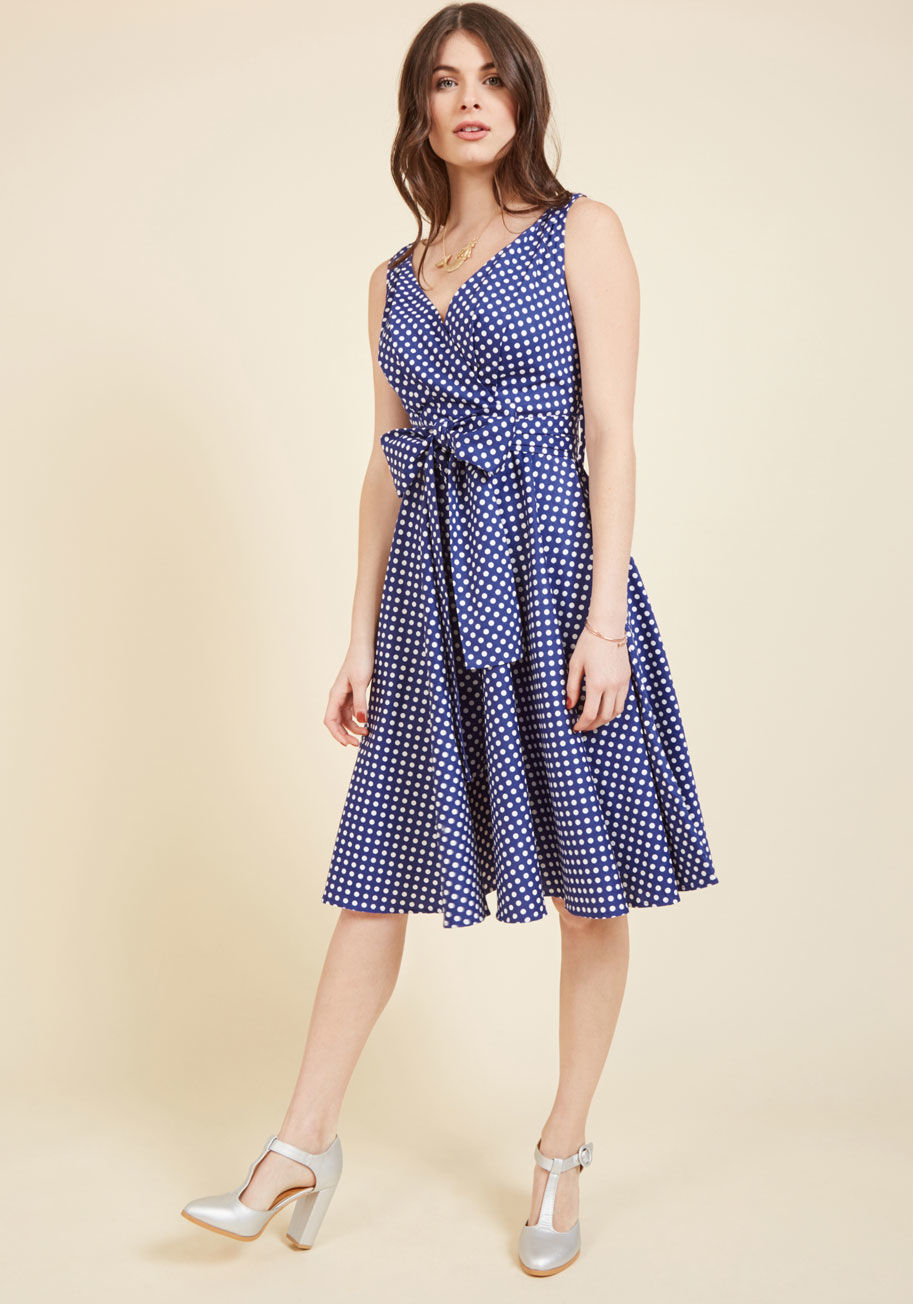 16202 - If the forecast is calling for clear skies, then you're calling for an outdoor fete to showcase this blue midi dress! With a pleated surplice bust, bright white dots, and a full, swingy skirt perfect for twirling