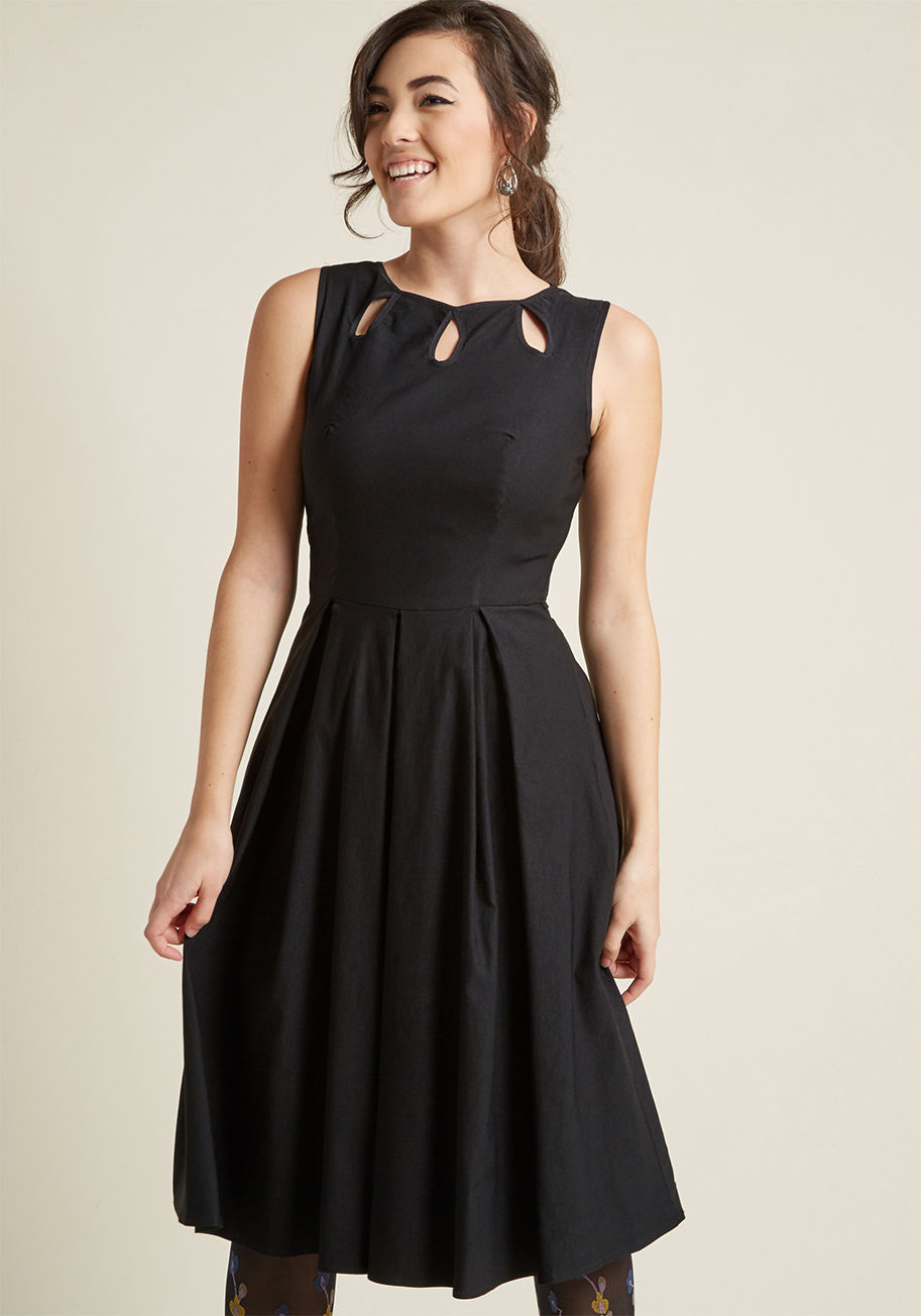 17427 - Unlock the perfect party ensemble by donning this black midi dress for your next get-together. Decorated with petal-shaped keyholes at the neck and backline, a pleated skirt, and stretch-touched fabric for flitting around the dance floor, this vintage-ins