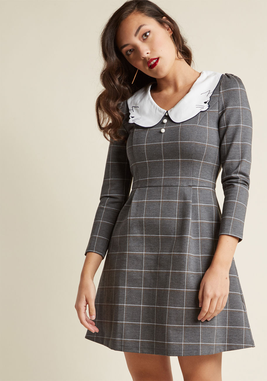 17AW-DRS-18 - If classic silhouettes with unexpected touches are right up your alley, you're going to adore this grey mini dress from Miss Patina! Crafted from structured knit fabric and enhanced with a navy-stitched kitty collar, white and tan plaid, and crisp pleats,