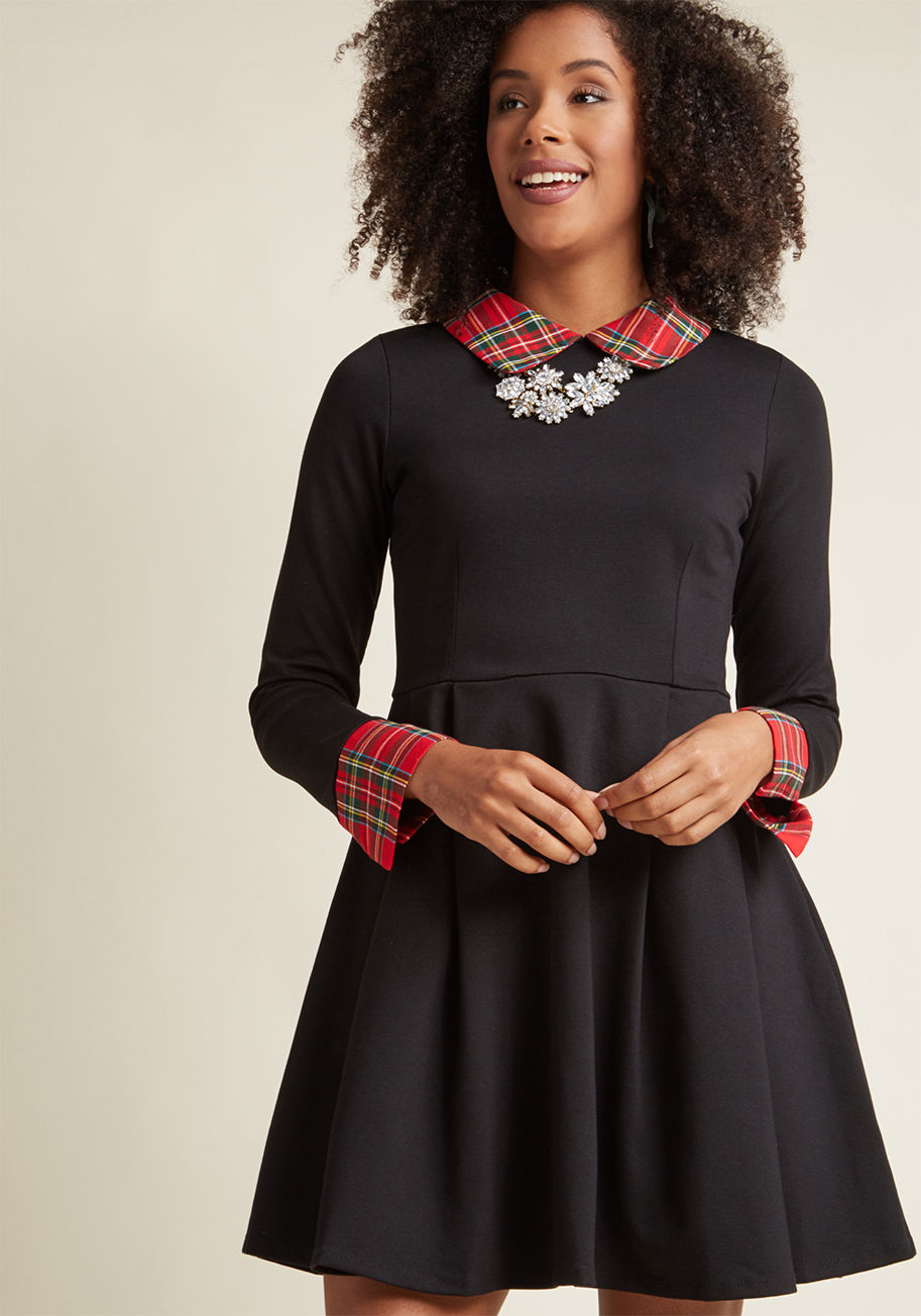 3154M-0052 - Nothing to wear? What a nightmare! Good thing this black dress is such a dream. Tipped with scholarly tartan plaid at the round collar and split cuffs, and touting a pleated skirt with pockets, this ponte knit frock assure you always have an A+ ensemble w