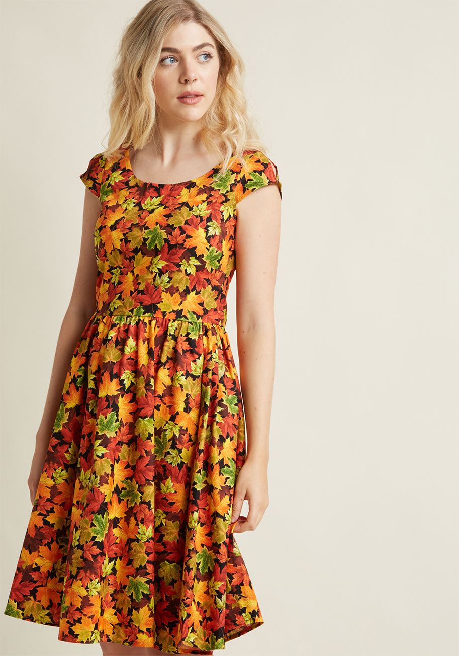 3501 - You declare your love for all things autumnal by wearing this patterned dress to your town&rsquo;s fall celebration! As you enjoy a caramel apple and visit craft vendors, fellow festival-goers admire the orange, red, gold, and black maple leaf pattern and