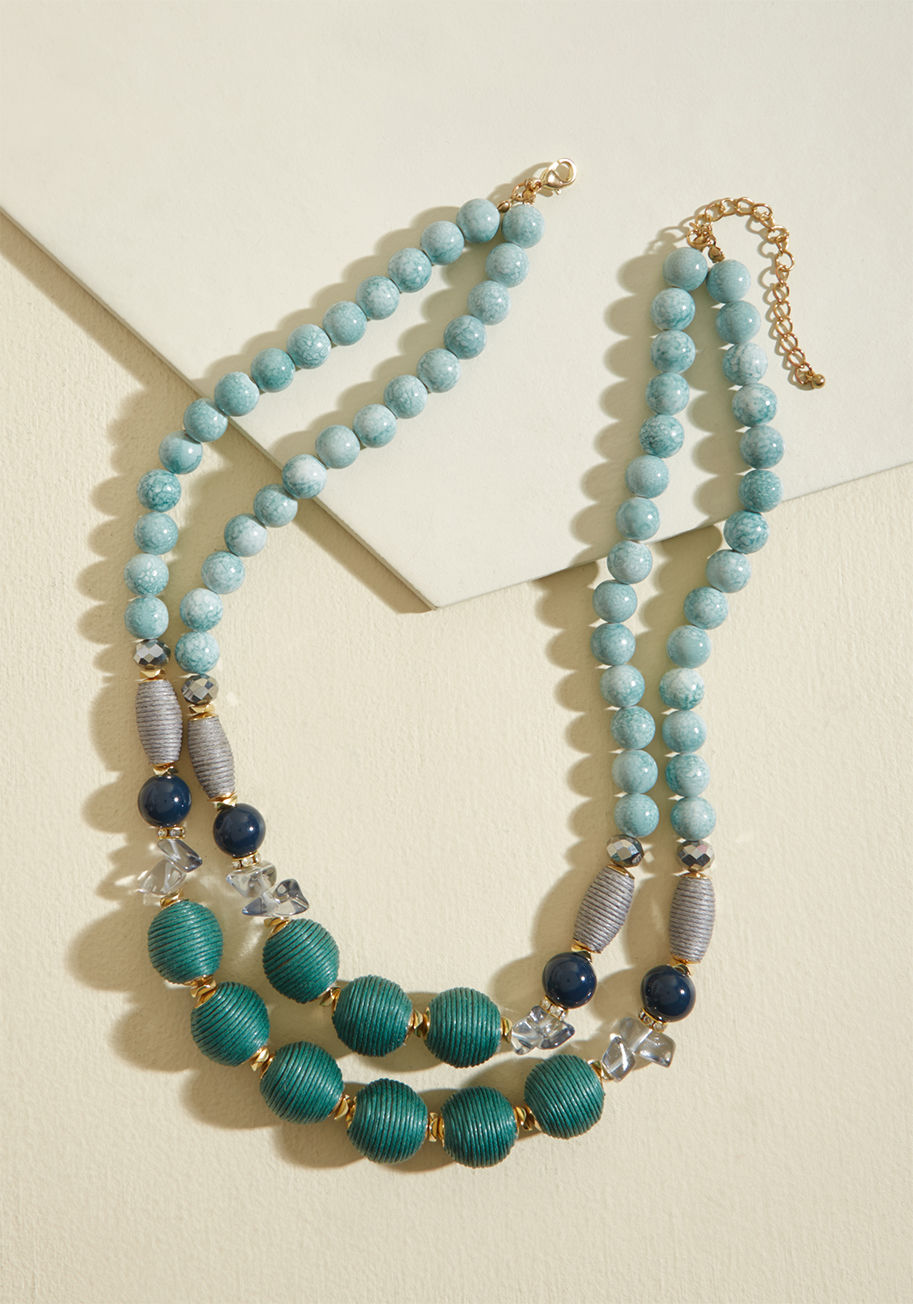 451075N-103 - With the simple addition of this beaded necklace, you take your look from sweet to complete! Dual strands of green, blue, and grey beads add texture and intrigue to this eye-catching accessory, as its gold accent hardware provides the perfect touch of shi