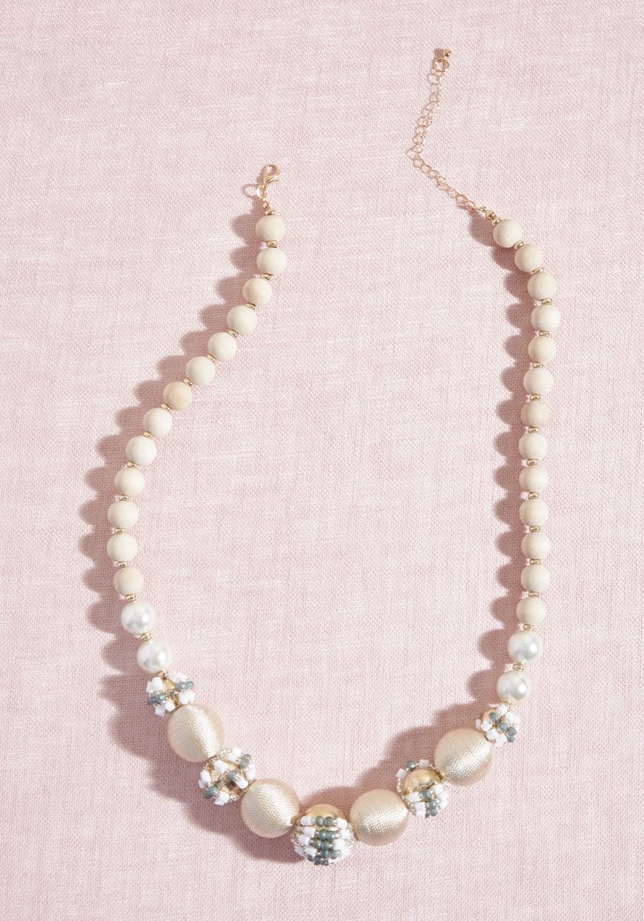 454229N-001 - According to your style rules, if it shines, you simply must have it - and this ivory necklace is no exception! Thread-wrapped spheres with a subtle sheen cozy up beside bulbs of grey and white beads, creating an accessory so indulgent, it's no wonder suc