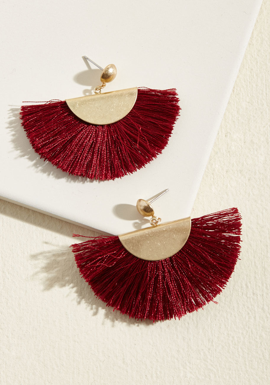 457651ER-001 - After your smile, the first thing onlookers will notice about your arrival is these fringed earrings! Hugged by brushed gold hemispheres dangling from round posts, the cranberry-colored tassels fanning out from this pair show the world you're sure of your