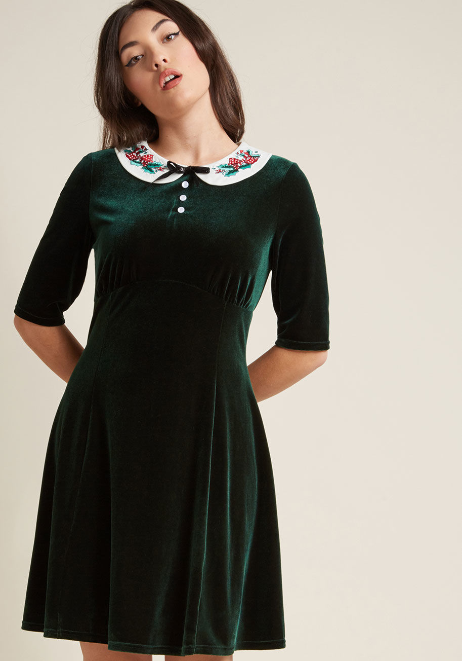 4769 - Move over gingerbread cookies and trimming the tree - this velvet dress is set to become a new holiday tradition! A retro number from Hell Bunny, this dark green frock is festive as can be with its white Peter Pan collar embroidered with candy canes and h