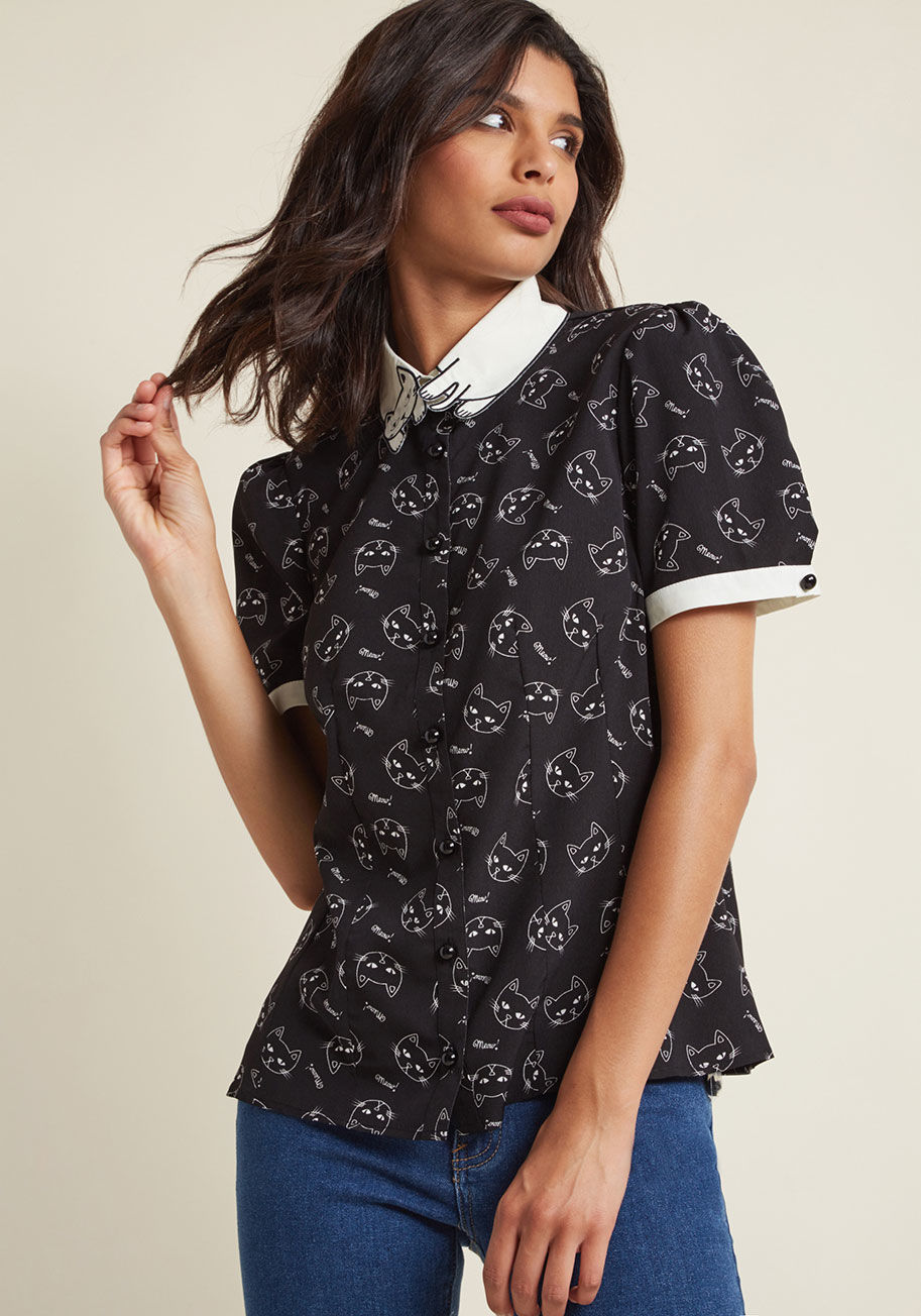 6621 - A true cat-lover like you is entitled to as many kitty-themed tops as she wants! Add this tailored, black and ivory blouse by Hell Bunny to your ever-growing collection feeling confident that the embroidered feline collar and tabby face pattern are both w