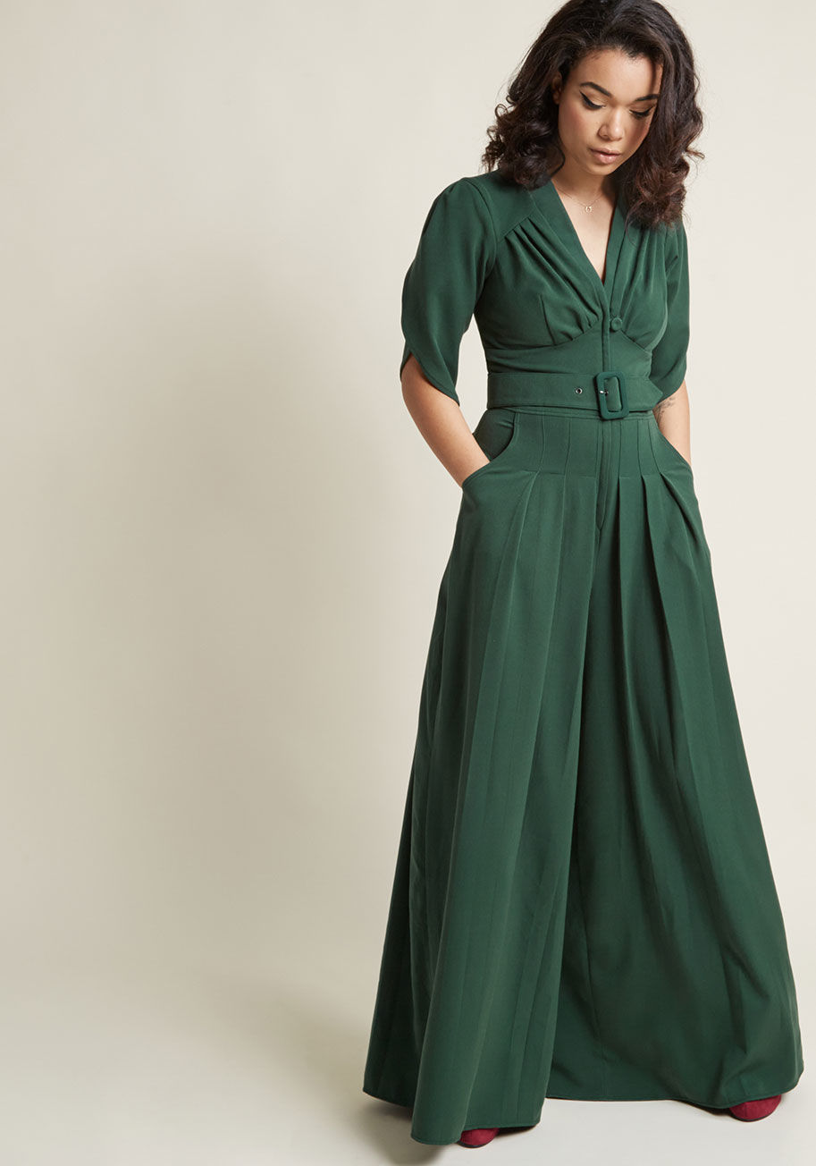 77510-PL - In this golden era of inspiration, you feel encouraged to sport this dark green jumpsuit. Inspirited by its gathered bust, tulip-style half sleeves, and broad waistband boasting a self belt, you step out like a starlet, swishing the pleated, skirt-like le